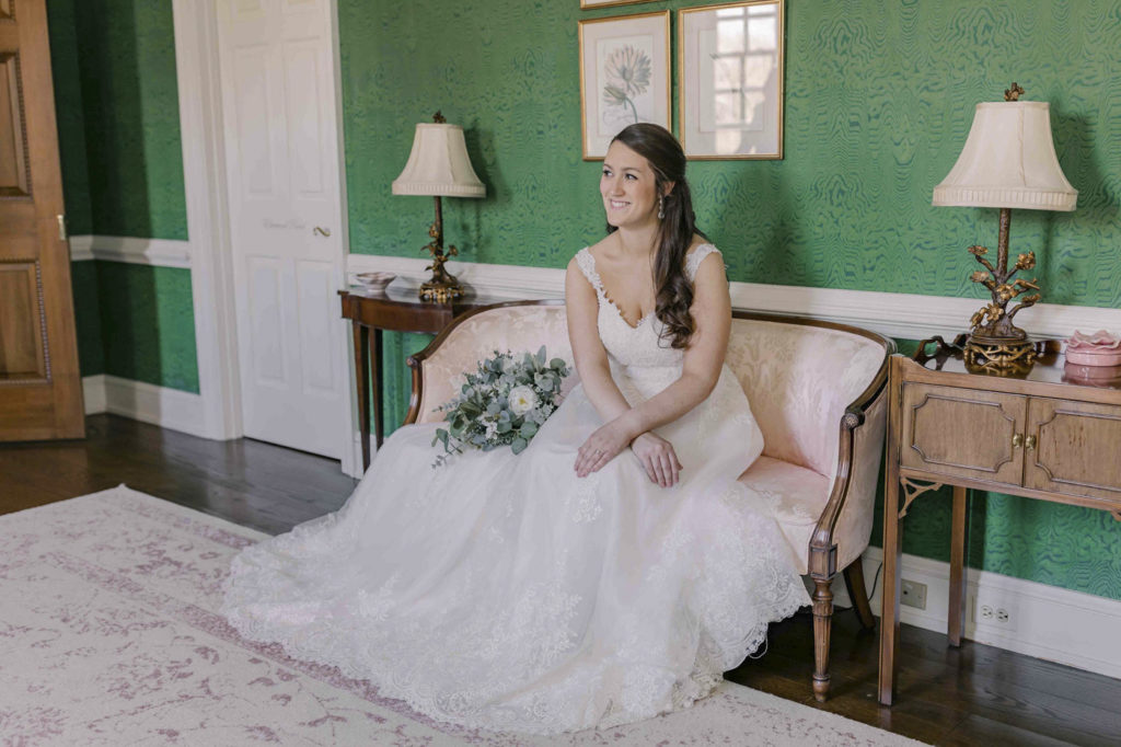 Bride sitting in beautiful green room during Bridal Portraits at The Estate at River Run