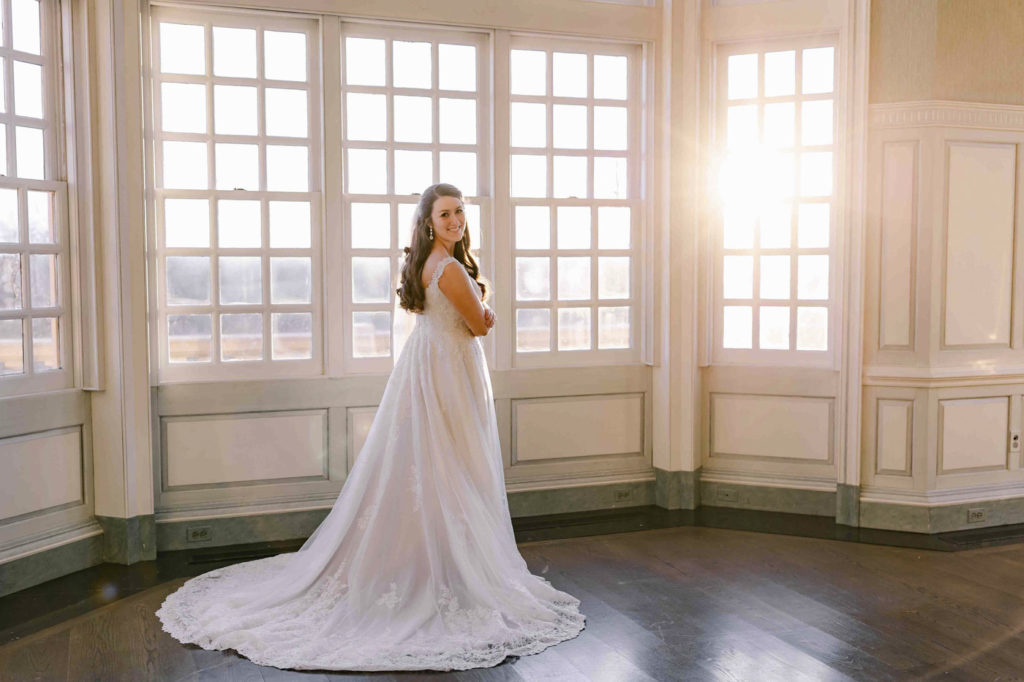 Gorgeous bride in front of window during Bridal Portraits at The Estate at River Run