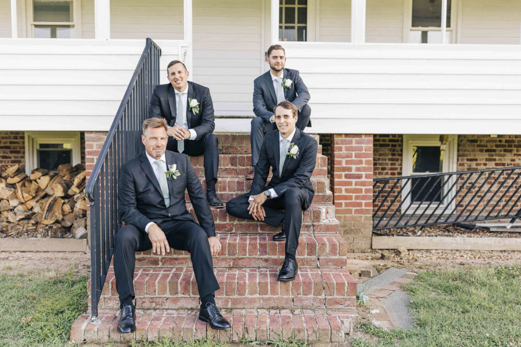 groomsmen pose for portraits during wedding day at the Cousiac Manor