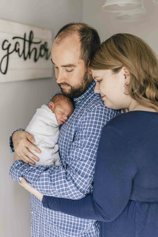 lifestyle newborn session portrait of parents and baby